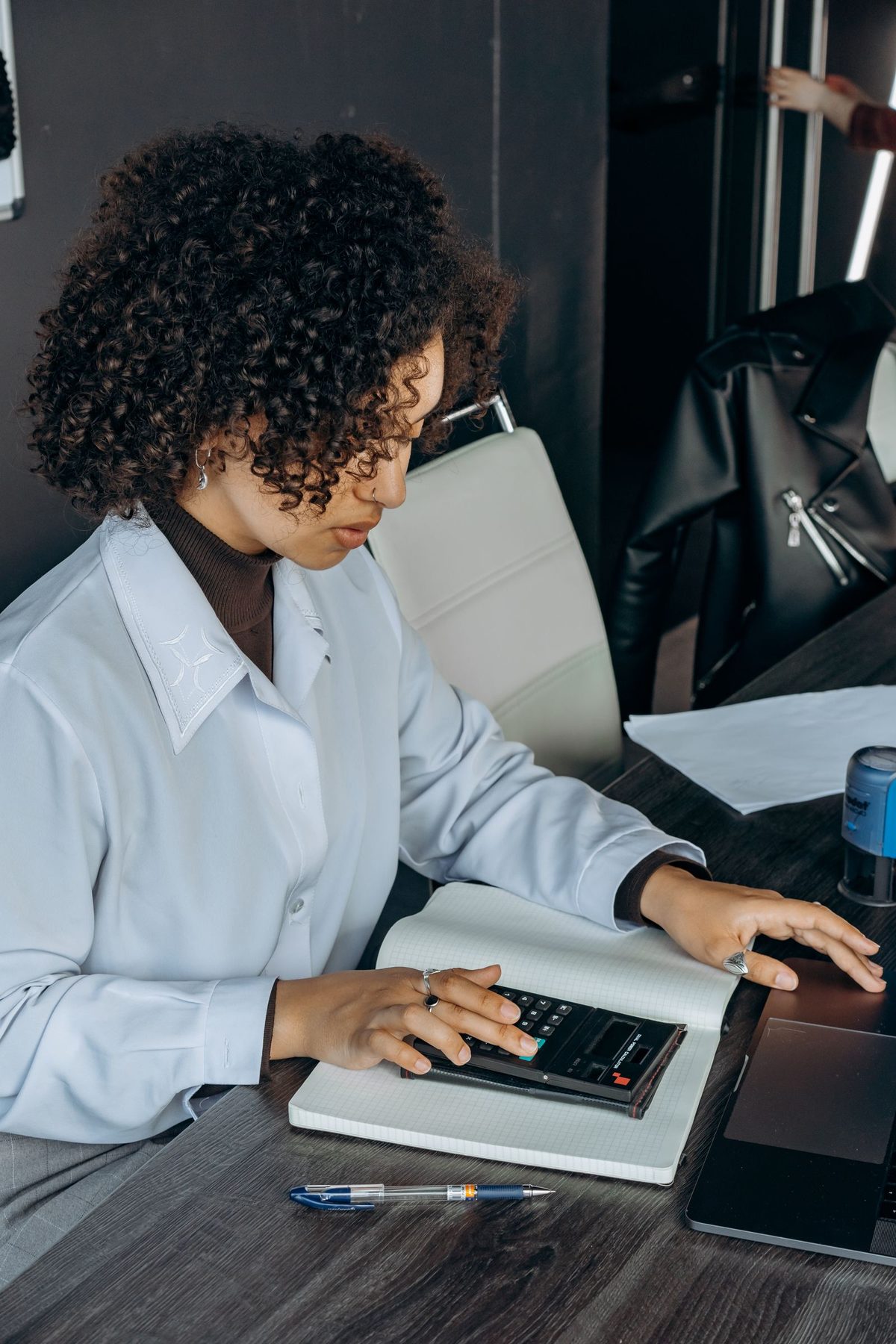 An accountant working through calculations at her desk