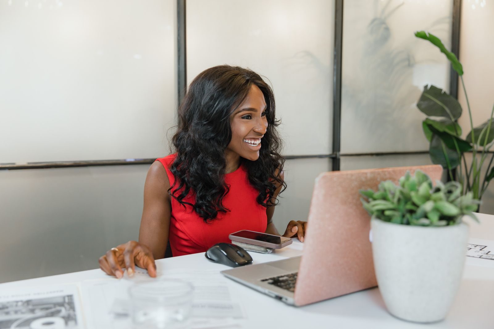 A business owner smiling at her desk